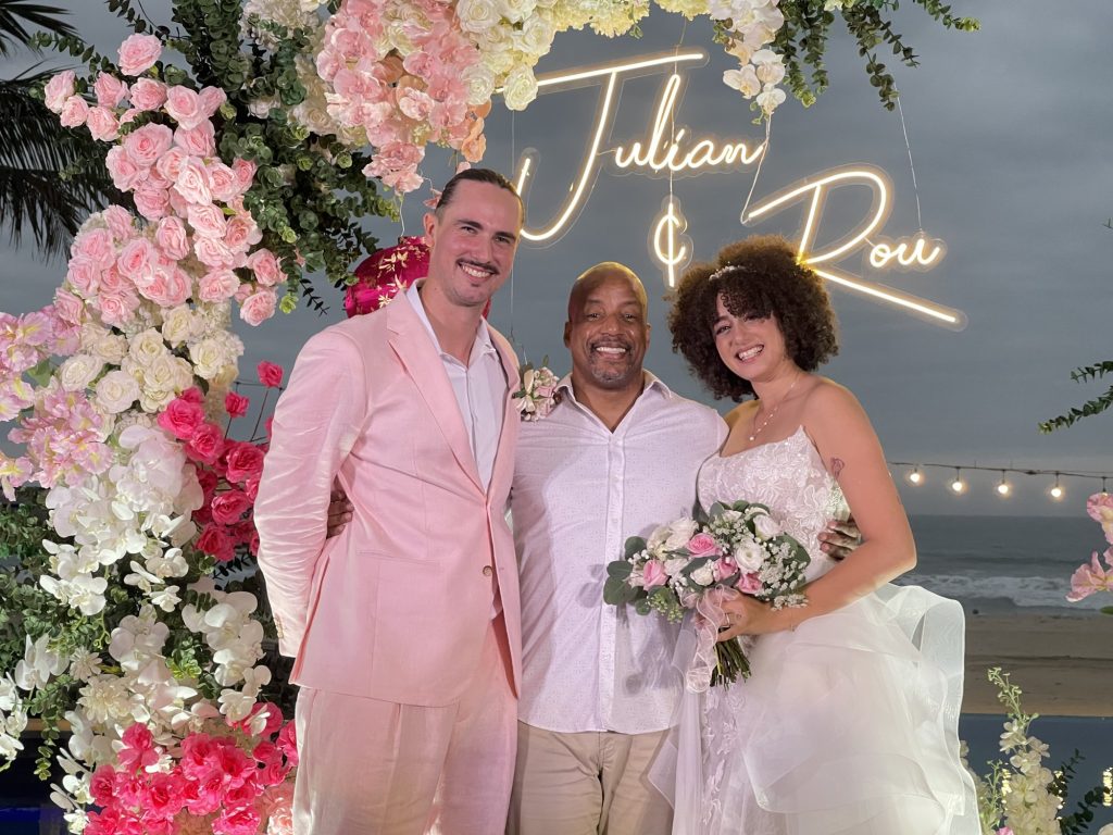 Emcee JK Hobson with the bride and groom at a seaside wedding in Vietnam
